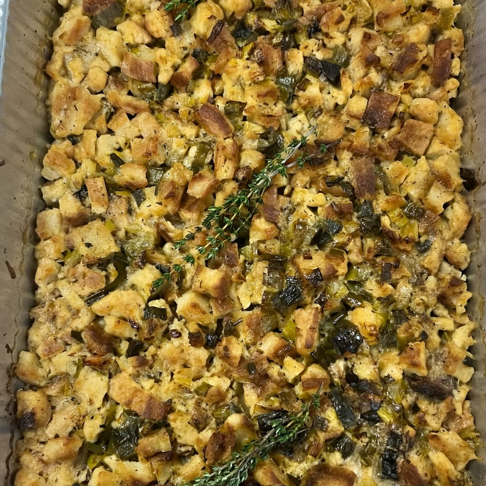Close-up of Djonisi’s Greek stuffing with bread cubes, herbs, and dark green vegetables.